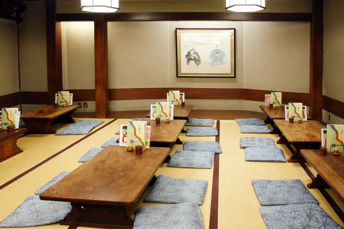 A tatami ryokan room prepared with a low table and floor cushions.